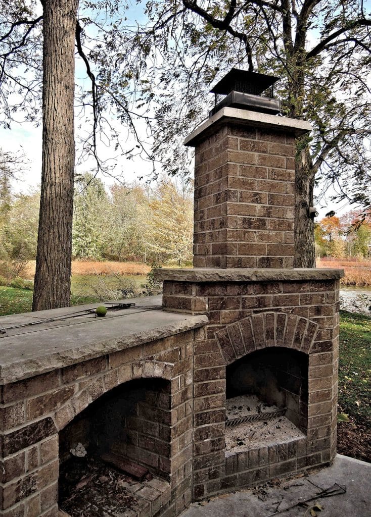 Rustic-looking outdoor masonry fireplace build