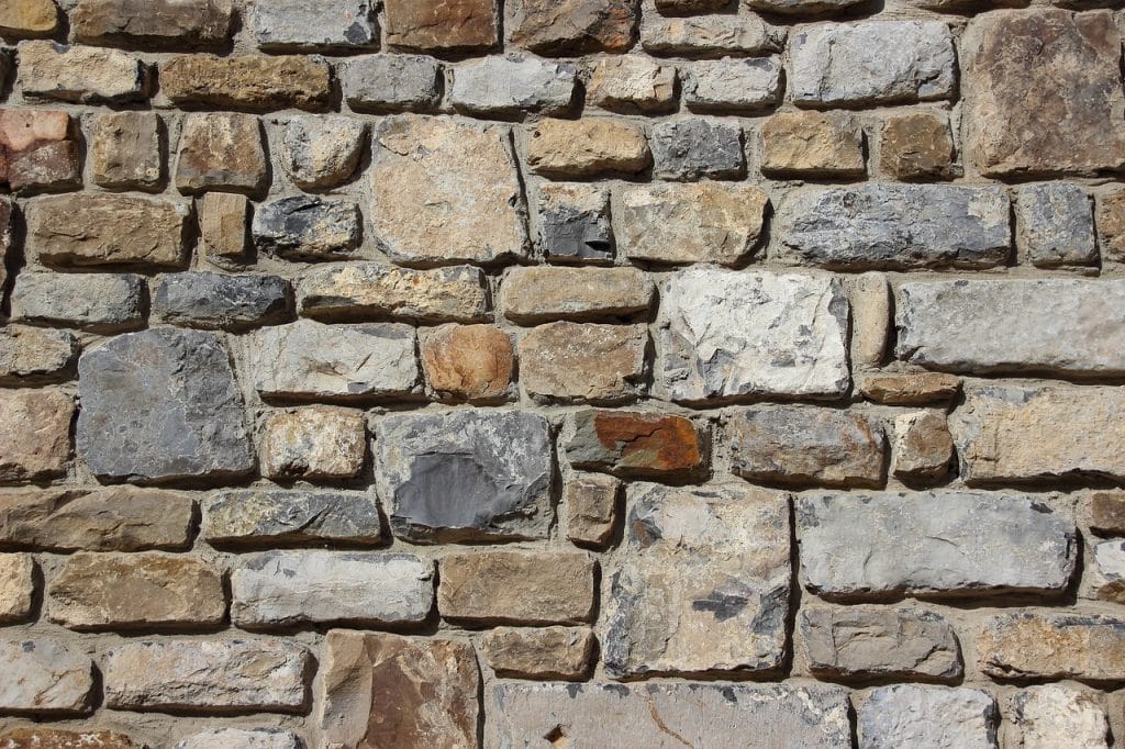 A very close view of a concrete stone masonry wall